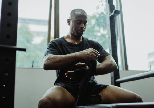 Man in sports wear sitting calmly preparing for daily activity