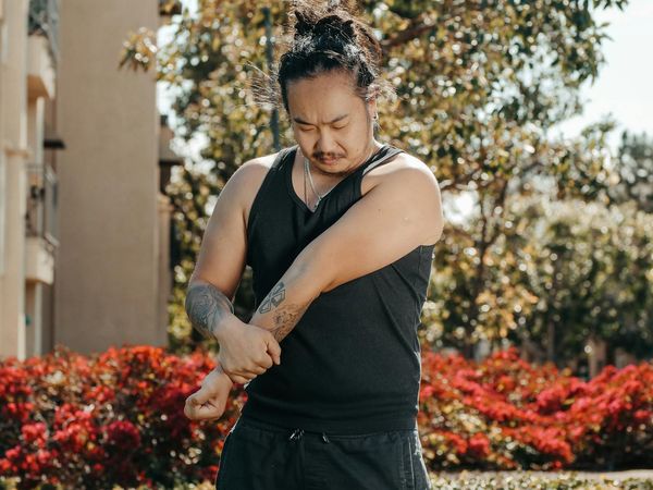 Man stretching arms toward the sun feeling energized